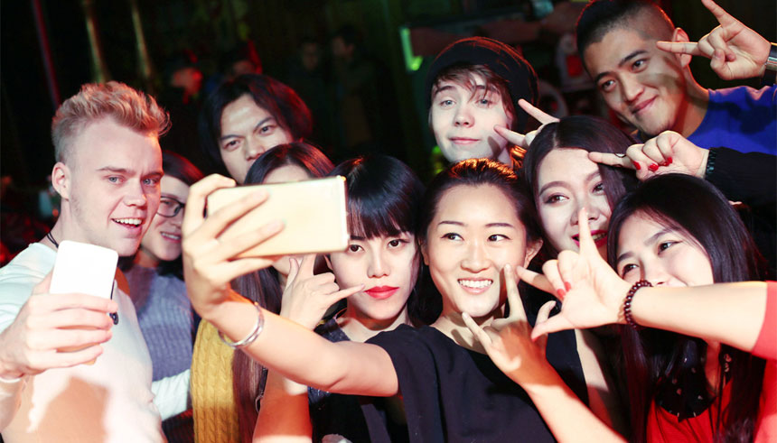 A group of Chinese millennials, consumers who are tech savvy, and increasingly influential in global markets, taking a selfie
